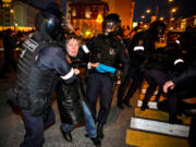 Police officers detain a woman Sept. 21, 2022, following calls to protest against the partial mobilization announced by the Russian president in Moscow.