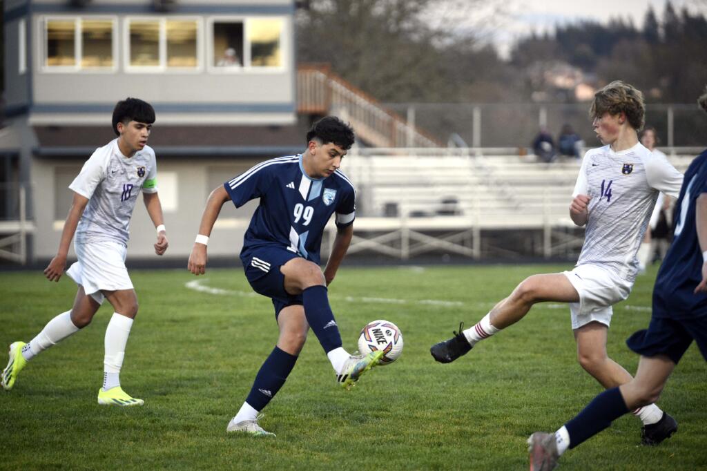 Hockinson's Alonzo Flores (99) flicks a pass by Columbia River's Pyotr Henrichs-Tarasenkov (14) during a 2A GSHL boys soccer match on Tuesday, March 19, 2024, at Hockinson High School.