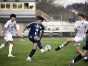 Hockinson's Alonzo Flores (99) flicks a pass by Columbia River's Pyotr Henrichs-Tarasenkov (14) during a 2A GSHL boys soccer match on Tuesday, March 19, 2024, at Hockinson High School.