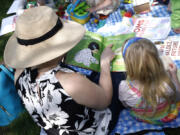 MomsRising members and their kids gather at a picnic on Capitol Hill to urge Congress to make child care affordable, pass paid leave, support care infrastructure, and raise the debt ceiling on May 17, 2023, in Washington, D.C. Women provide nearly 80% of household services that are crucial to sustaining spending and living standards, such as childcare and do-it-yourself home repairs.