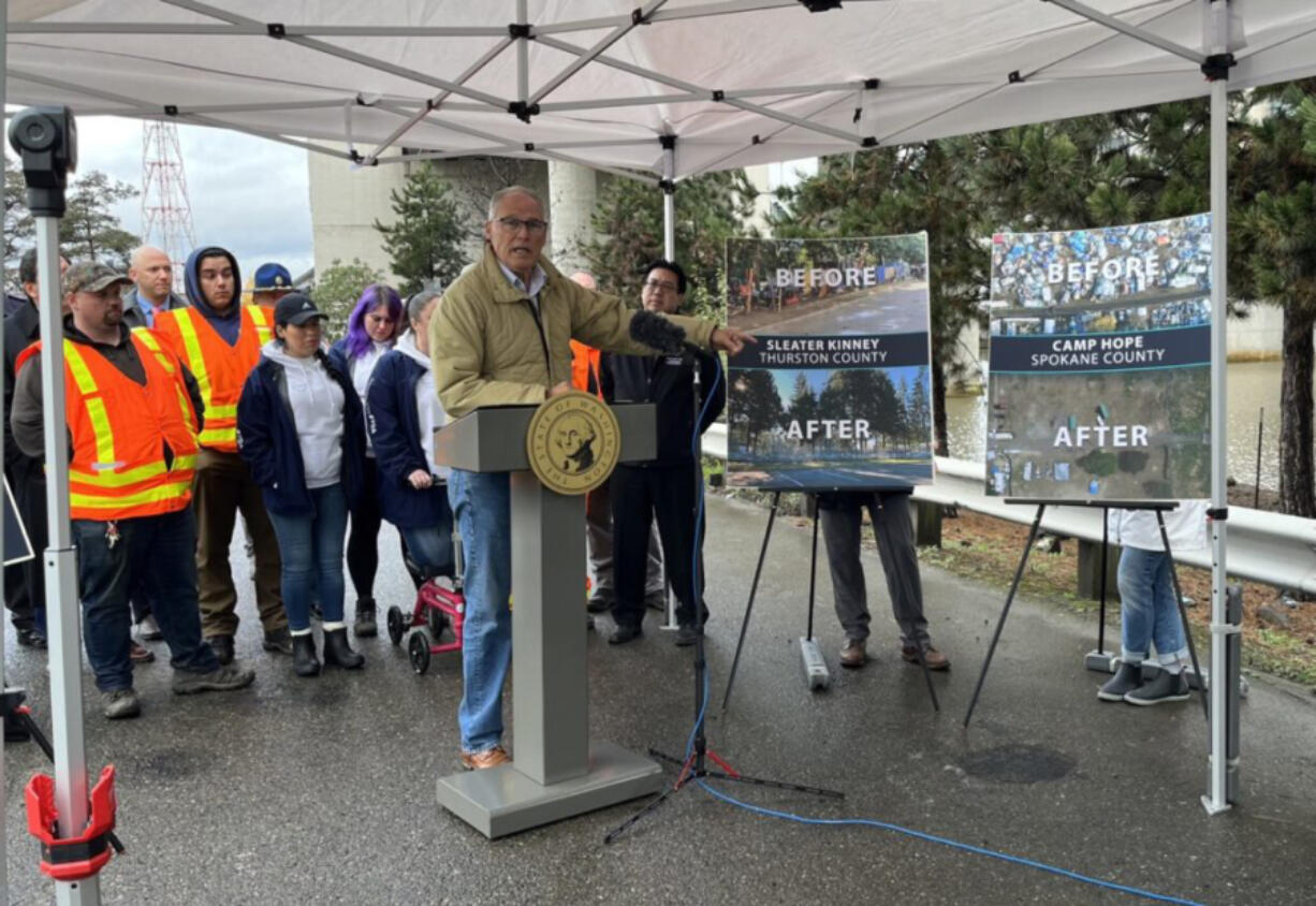 Gov. Jay Inslee points to the work his homeless encampment initiative has done to clear encampments and transition people into housing. Inslee released his budget proposals surrounding housing and homelessness programs at the site of a former encampment in Seattle.