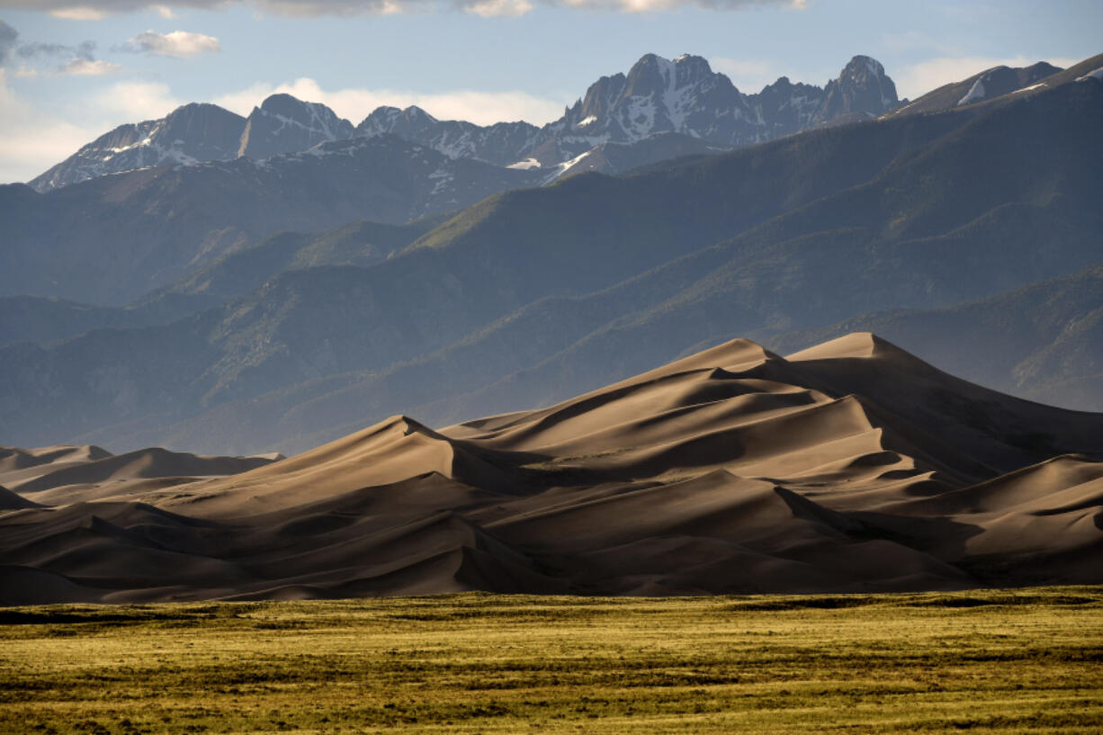 The Great Sand Dunes are lit by the setting sun near Mosca, Colo. (Helen H.