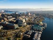 A drone view of University of Washington, Portage Bay, I-520 Bridge and the Cascade Mountains.