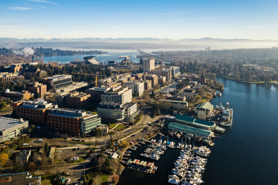 A drone view of University of Washington, Portage Bay, I-520 Bridge and the Cascade Mountains.