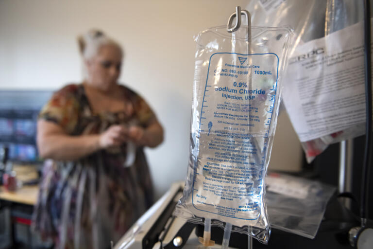 Amy Ruger of Vancouver prepares dialysis treatment for her boyfriend.