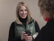 Leslie Lewallen, center, who is running as a Republican to represent the 3rd Congressional District, talks with supporters at her campaign headquarters in Camas on Friday afternoon.