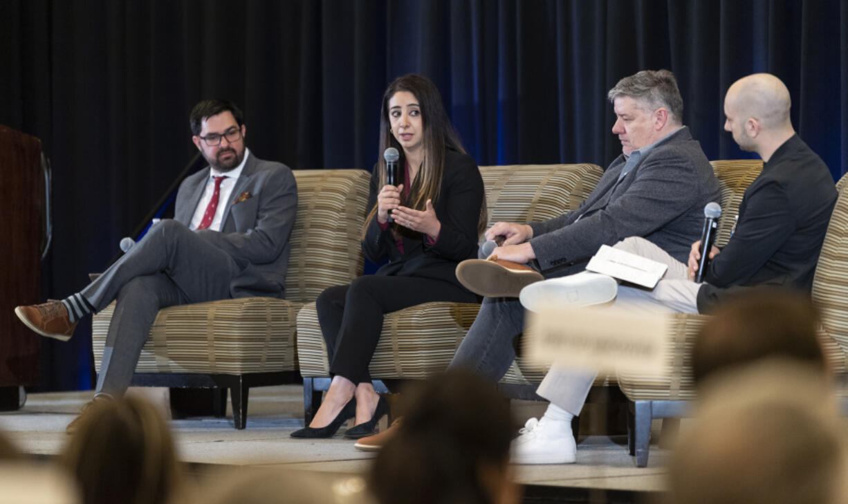 David Adkins, a senior engineering manager at Meta, from left, listens to fellow panelist Krystal Daibes Higgins, vice president of equity research at Ferguson Wellman, with Dave Barcos, director of business development at Formos, and Will Campbell, associate editor at The Columbian, on Tuesday, March 5, 2024, at The Columbian&Ccedil;&fnof;&Ugrave;s annual Economic Forecast Breakfast at Hilton Vancouver.