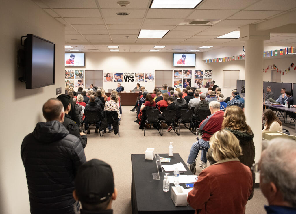 Vancouver Public Schools board members talk in front of a packed room Tuesday, March 12, 2024, during a Vancouver Public Schools board meeting at the Bates Center for Educational Leadership. During the meeting, the VPS board unanimously approved $35 million in budget cuts for the district.