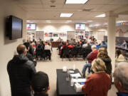 Vancouver Public Schools board members talk in front of a packed room Tuesday, March 12, 2024, during a Vancouver Public Schools board meeting at the Bates Center for Educational Leadership. During the meeting, the VPS board unanimously approved $35 million in budget cuts for the district.