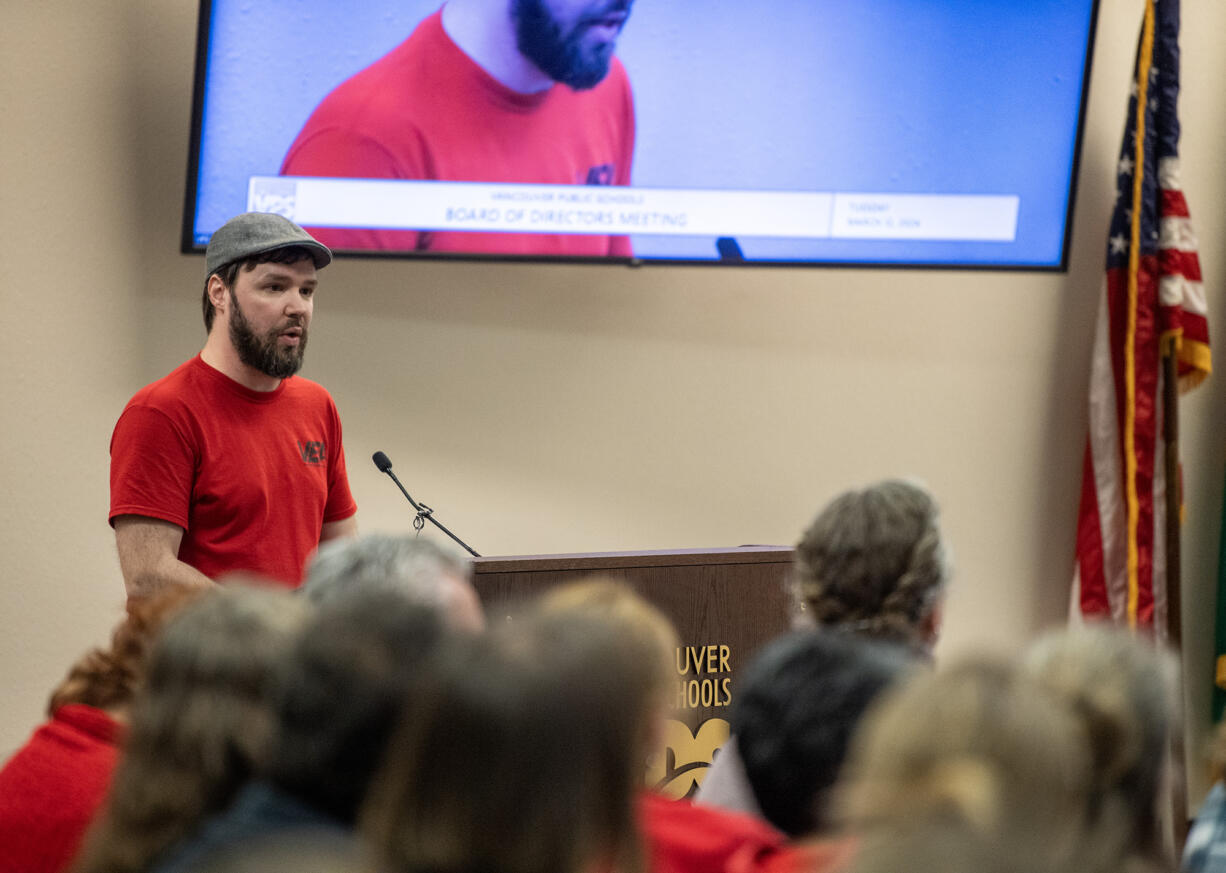 Fort Vancouver High School choir teacher Benjamin Bouton  addresses the Vancouver Public Schools board Tuesday, March 12, 2024, during a meeting at the Bates Center for Educational Leadership. During the meeting, the VPS board unanimously approved $35 million in budget cuts for the district.