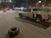 A Dodge pickup truck sits on East 15th Avenue in downtown Vancouver after being struck by a motorcycle in a fatal collision at the intersection with Main Street on Friday, March 15, 2024.