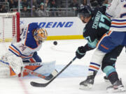 Edmonton Oilers goaltender Stuart Skinner (74) makes a save on shot by Seattle Kraken center Jaden Schwartz (17) during the first period of an NHL hockey game Saturday, March 2, 2024, in Seattle.