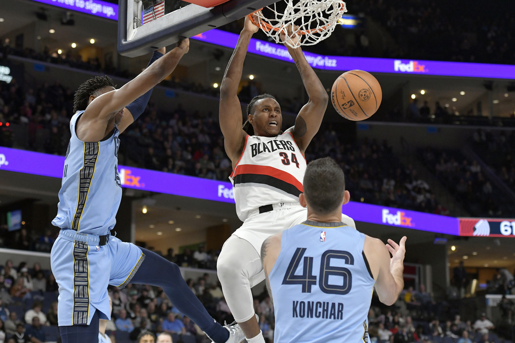 Portland Trail Blazers forward Jabari Walker (34) dunks between Memphis Grizzlies forward GG Jackson II, left, and guard John Konchar (46) in the second half of an NBA basketball game Saturday, March 2, 2024, in Memphis, Tenn.