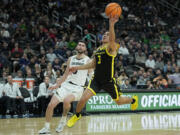 Oregon guard Jackson Shelstad (3) shoots over Colorado guard Luke O'Brien (0) during the first half of an NCAA college basketball game in the championship of the Pac-12 tournament Saturday, March 16, 2024, in Las Vegas.