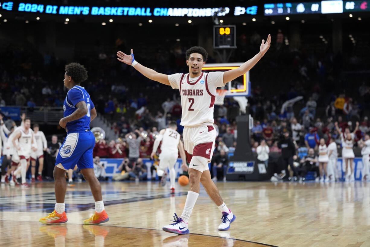 Washington State's Myles Rice (2) celebrates as Drake's Atin Wright, left, heads off the floor following a first-round college basketball game in the NCAA Tournament Thursday, March 21, 2024, in Omaha, Neb. Washington State won 66-61.