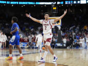 Washington State's Myles Rice (2) celebrates as Drake's Atin Wright, left, heads off the floor following a first-round college basketball game in the NCAA Tournament Thursday, March 21, 2024, in Omaha, Neb. Washington State won 66-61.