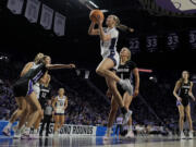 Kansas State guard Serena Sundell (4) gets past Portland guard McKelle Meek (1) to put up a shot during the first half of a first-round college basketball game in the women's NCAA Tournament in Manhattan, Kan., Friday, March 22, 2024, in Manhattan, Kan.