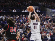 Gonzaga guard Kayleigh Truong (11) shoots next to Utah guard Kennady McQueen (24) during the first half of a second-round college basketball game in the NCAA Tournament in Spokane, Wash., Monday, March 25, 2024.