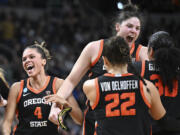 Oregon State players celebrate after defeating Notre Dame in a Sweet Sixteen round college basketball game during the NCAA Tournament, Friday, March 29, 2024, in Albany, N.Y.
