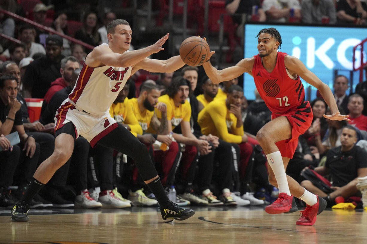 Portland Trail Blazers guard Rayan Rupert (72) steals a pass intended for Miami Heat forward Nikola Jovic (5) during the first half of an NBA basketball game, Friday, March 29, 2024, in Miami.