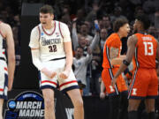 UConn center Donovan Clingan (32) celebrates after his dunk against Illinois during the first half of the Elite 8 college basketball game in the men's NCAA Tournament, Saturday, March 30, 2024, in Boston.