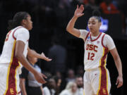 Southern California center Rayah Marshall, left, and guard JuJu Watkins (12) greet each other on the court during the first half of a Sweet 16 college basketball game against Baylor in the women's NCAA Tournament, Saturday, March 30, 2024, in Portland, Ore.