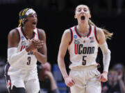 UConn guard Paige Bueckers (5) and UConn forward Aaliyah Edwards (3) react during the first half of the team's Sweet 16 college basketball game against Duke in the women's NCAA Tournament, Saturday, March 30, 2024, in Portland, Ore.