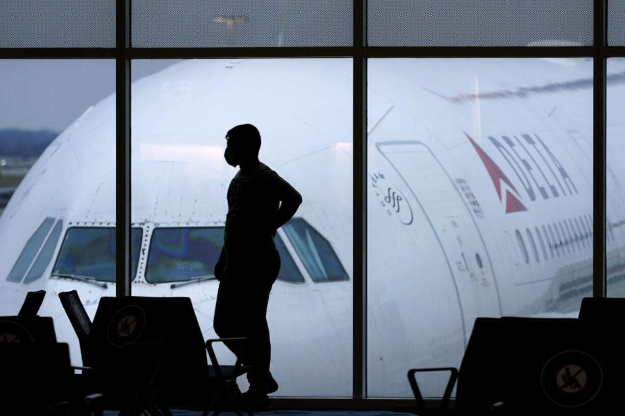 FILE - A passenger waits for a Delta Airlines flight at Hartsfield-Jackson International Airport in Atlanta on Feb. 18, 2021. The U.S. Department of Transportation said Thursday, March 21, 2024, that it will review how airlines protect personal information about their passengers and whether they are making money by sharing that information with other parties.