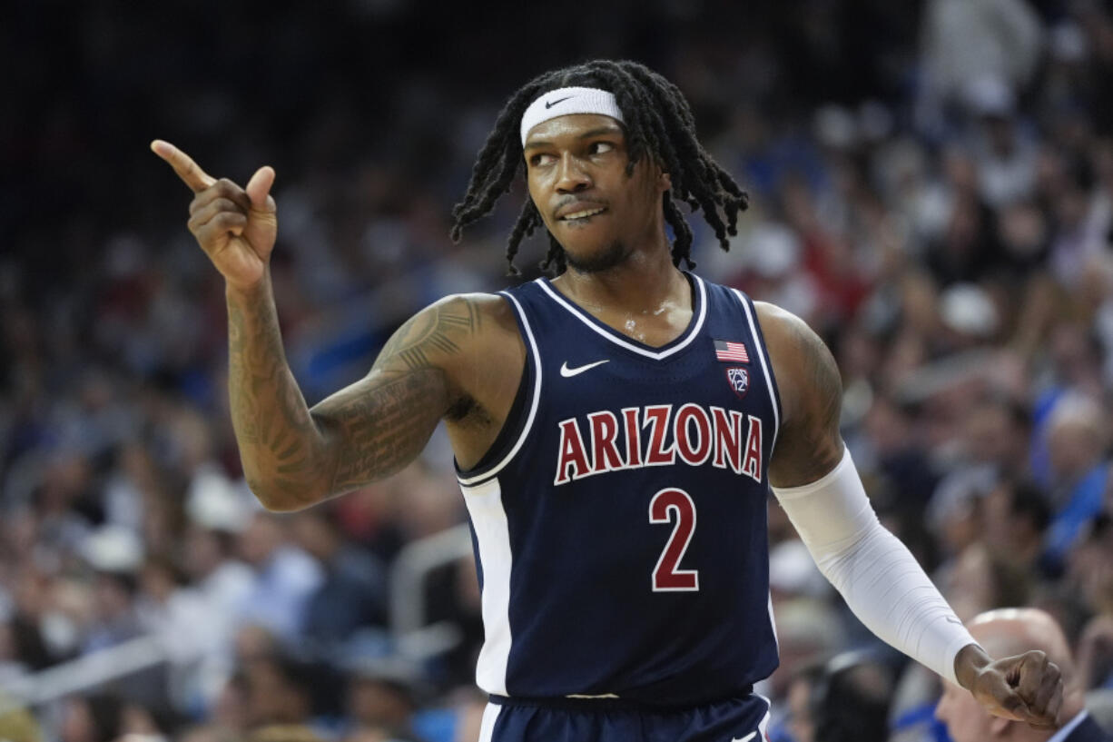 Arizona guard Caleb Love (2) points to a teammate during the first half of an NCAA college basketball game against UCLA in Los Angeles, Thursday, March 7, 2024. (AP Photo/Jae C.