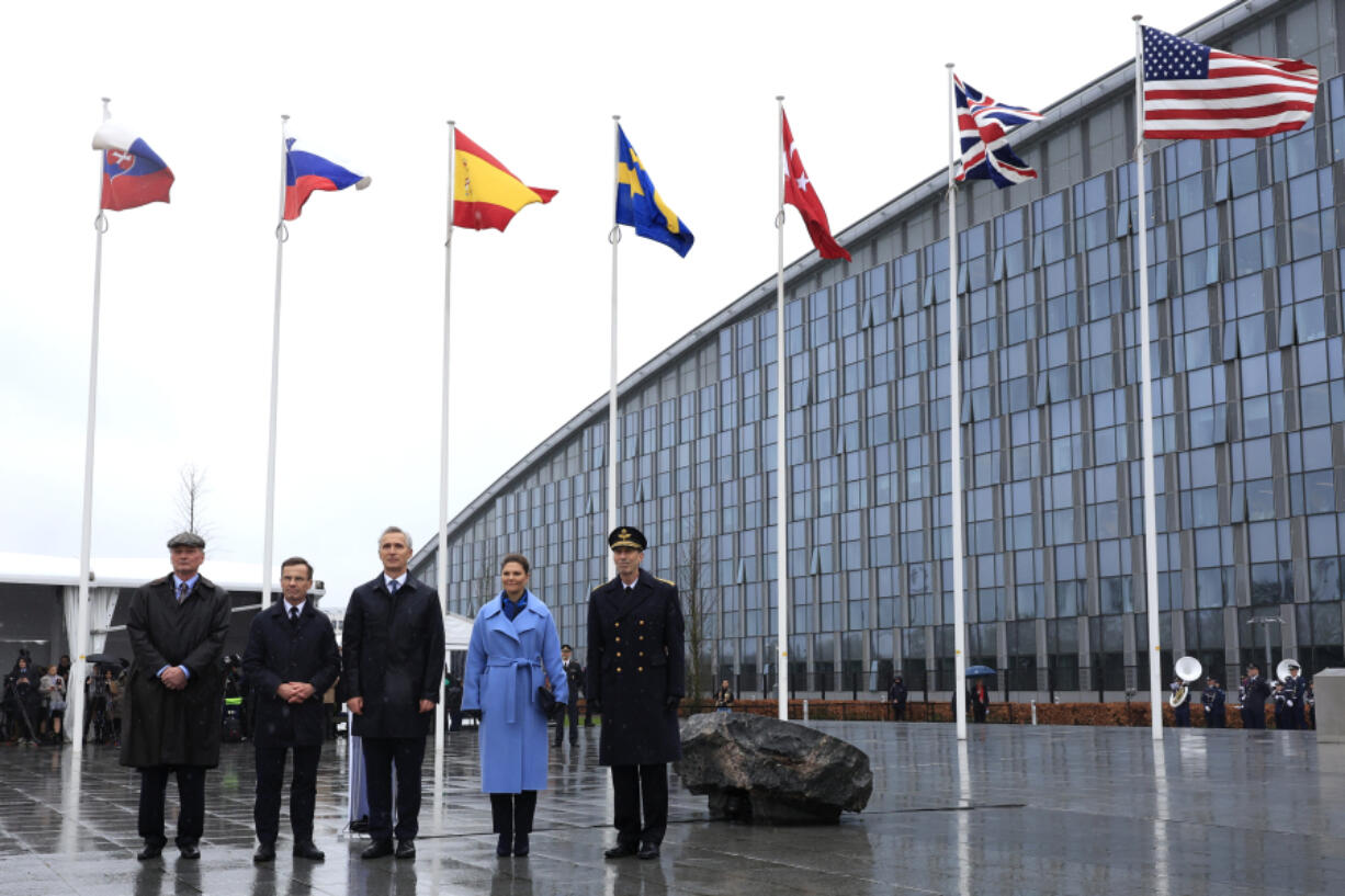 From second left, Sweden&rsquo;s Prime Minister Ulf Kristersson, NATO Secretary General Jens Stoltenberg and Sweden&rsquo;s Crown Princess Victoria pose in front of the flag of Sweden and other alliance nations after a ceremony to mark the accession of Sweden to NATO at NATO headquarters in Brussels, Monday, March 11, 2024.