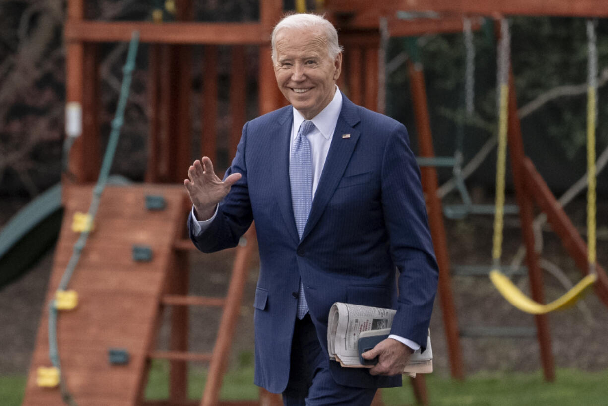 President Joe Biden waves to members of the media as he walks toward Marine One on the South Lawn of the White House in Washington, Friday, March 22, 2024, to travel to Wilmington, Del.