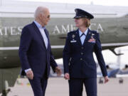 President Joe Biden, escorted by Col. Angela Ochoa, commander of the 89th Airlift Wing, arrives to board Air Force One at Andrews Air Force Base, Md., Tuesday March 19, 2024, en route to Nevada.