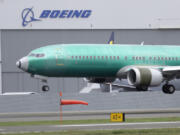 FILE - In this April 10, 2019, file photo, a Boeing 737 Max 8 airplane lands following a test flight at Boeing Field in Seattle. Federal investigators have confirmed in a report Thursday, March 7, 2023, an account by pilots who say the rudder controls on their Boeing Max jetliner failed during a landing last month. (AP Photo/Ted S.