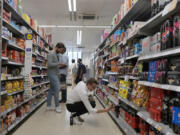 FILE - Shoppers buy food in a supermarket in London, on Aug. 17, 2022. Food prices and overall inflation will rise as temperatures climb with climate change, a new study by an environmental scientist and the European Central Bank found.