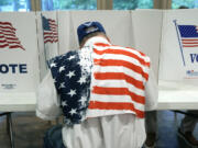 FILE - A patriotic voter sits at a voting kiosk and selects his choices in a party primary in Jackson, Miss., Tuesday, Aug. 8, 2023. Super Tuesday put former President Donald Trump within reach of clinching his third consecutive Republican presidential nomination. But it may be Republican voters in Georgia, Hawaii, Mississippi and Washington who put him over the top. President Joe Biden is also competing in presidential contests that day, but the earliest he can clinch his party&#039;s nomination is a week later on March 19. (AP Photo/Rogelio V.