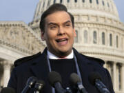 FILE - Rep. George Santos, R-N.Y., faces reporters at the Capitol, Nov. 30, 2023, in Washington. Santos, who was expelled from the House of Representatives in December and faces federal charges of defrauding donors to his 2022 campaign, announced on social media that he is running for Congress again. (AP Photo/J.