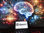 FILE - The OpenAI logo is displayed on a cell phone with an image on a computer monitor generated by ChatGPT&rsquo;s Dall-E text-to-image model, Friday, Dec. 8, 2023, in Boston. The maker of ChatGPT is now diving into the world of AI-generated video. Meet Sora &mdash; OpenAI&rsquo;s new text-to-video generator. The tool, which the San Francisco-based company unveiled on Thursday, Feb. 16, 2024 uses generative artificial intelligence to instantly create short videos based on written commands.