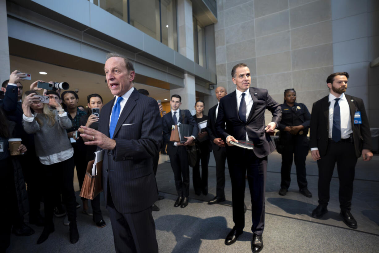 Hunter Biden, son of President Joe Biden, center, pauses as attorney Abbe Lowell, left, speaks to reporters following a closed-door deposition in the Republican-led investigation into the Biden family, on Capitol Hill in Washington, Wednesday, Feb. 28, 2024. (AP Photo/J.