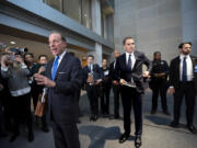 Hunter Biden, son of President Joe Biden, center, pauses as attorney Abbe Lowell, left, speaks to reporters following a closed-door deposition in the Republican-led investigation into the Biden family, on Capitol Hill in Washington, Wednesday, Feb. 28, 2024. (AP Photo/J.