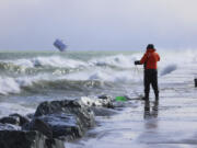 Rae-Ann Eifert, a lake monitor for the Wisconsin Department of Natural Resources,  braved sub-freezing temperatures to gather buckets of water for testing off a Lake Michigan breakwater in Racine, Wis., on Feb. 28, 2024, as part of an effort across the Great Lakes to understand the effects of an iceless winter.  Unseasonable warmth has left the Great Lakes all but devoid of ice, leaving scientists scrambling to understand the consequences as climate change accelerates.