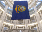 FILE - The Idaho state flag hangs in the State Capitol in Boise, Idaho, Jan. 9, 2023. The Idaho Senate is expected to take a final vote on Monday, March 18, 2024, on a bill that would prohibit transgender and nonbinary Idahoans enrolled in Medicaid, or state employees enrolled in the state&#039;s insurance plan, from obtaining gender-affirming care.