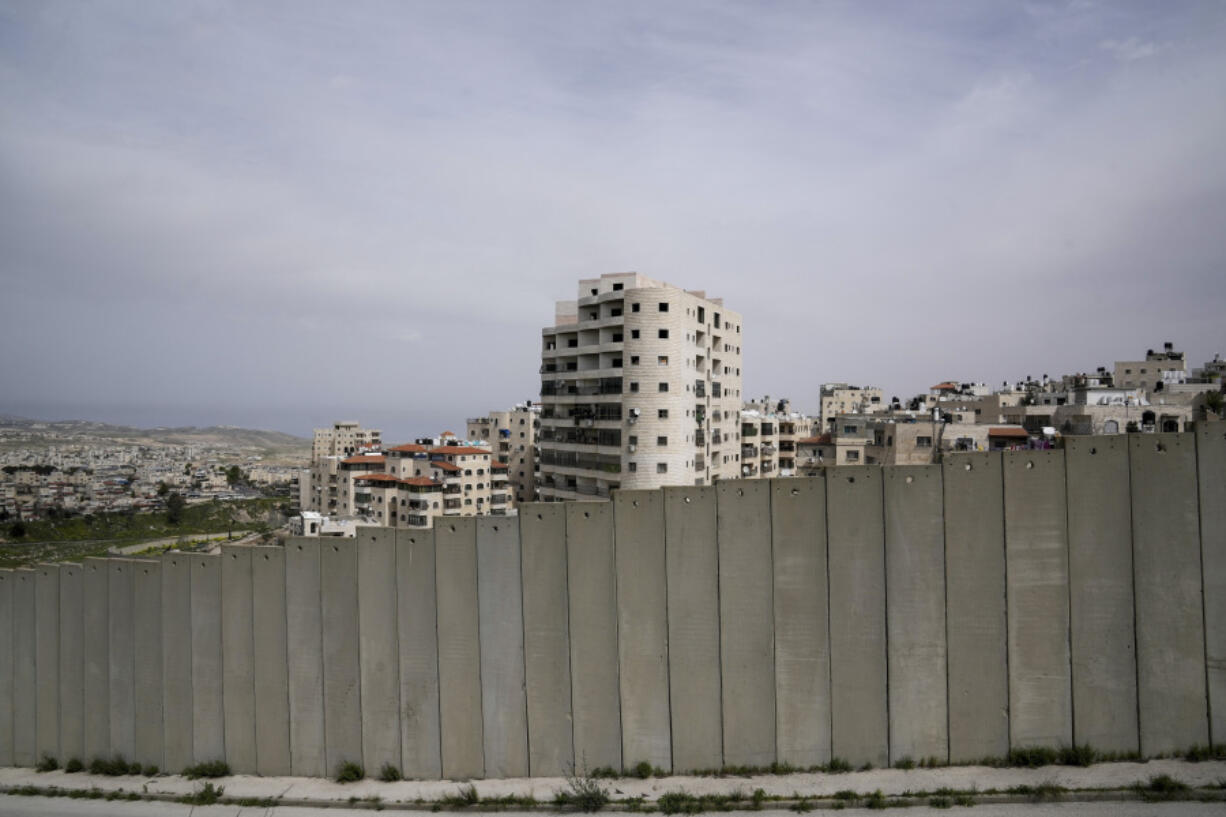 A view of Shuafat refugee camp is seen behind a section of Israel&rsquo;s separation barrier in Jerusalem on Sunday, March 17, 2024. Palestinian boy Rami Halhouli, 12, was fatally shot by an Israeli police officer while launching a firework in the refugee camp on March 12.