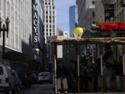 A cable car traveling along Powell Street passes Macy&rsquo;s near Union Square in San Francisco on Tuesday, Feb. 27, 2024. Macy&rsquo;s will close 150 unproductive namesake stores over the next three years, including 50 by year-end, the department store operator said Tuesday after posting a fourth-quarter loss and declining sales.