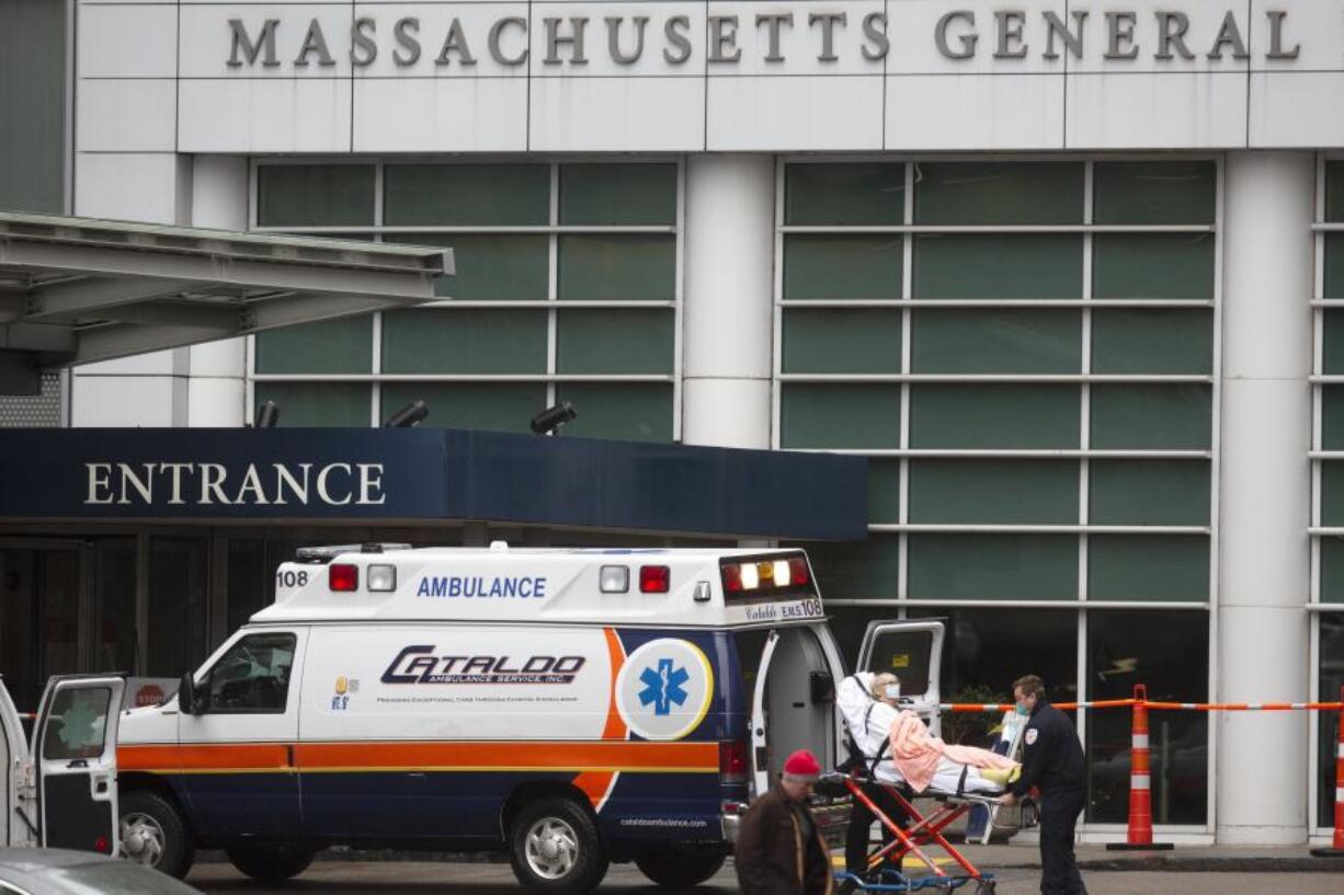 FILE - A patient arrives at the Massachusetts General Hospital emergency entrance, Friday, April 3, 2020, in Boston.  Doctors in Boston say they have transplanted a genetically modified pig kidney into a 62-year-old patient. Massachusetts General Hospital said Thursday, March 21, 2024, it&rsquo;s the first time a pig kidney has been transplanted into a living person.