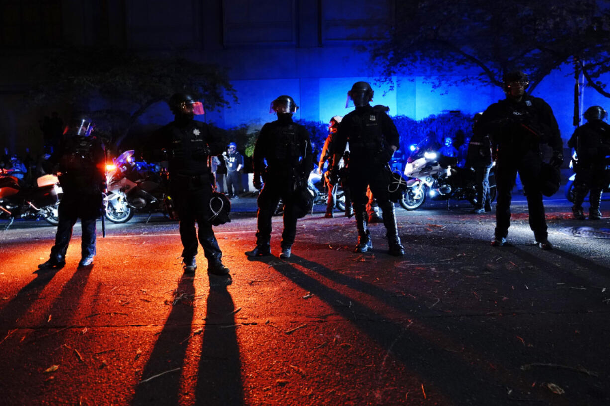 FILE - Portland police stand in a street during protests, Saturday, Sept. 26, 2020, in Portland. City leaders in Portland, on Wednesday, March 20, 2024, are reviving a protest response team though some residents are skeptical and say their confidence was eroded by the police response to 2020 racial justice protests in the city.