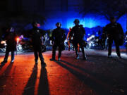 FILE - Portland police stand in a street during protests, Saturday, Sept. 26, 2020, in Portland. City leaders in Portland, on Wednesday, March 20, 2024, are reviving a protest response team though some residents are skeptical and say their confidence was eroded by the police response to 2020 racial justice protests in the city.