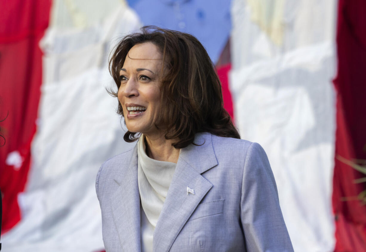 Vice President Kamala Harris stands in front of a Puerto Rican flag, in San Juan, Puerto Rico, Friday, March 22, 2024. Harris visited Puerto Rico on Friday as part of a whirlwind trip to tout the federal aid the U.S. territory has received following deadly hurricanes and attend a Democratic fundraiser.