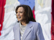 Vice President Kamala Harris stands in front of a Puerto Rican flag, in San Juan, Puerto Rico, Friday, March 22, 2024. Harris visited Puerto Rico on Friday as part of a whirlwind trip to tout the federal aid the U.S. territory has received following deadly hurricanes and attend a Democratic fundraiser.