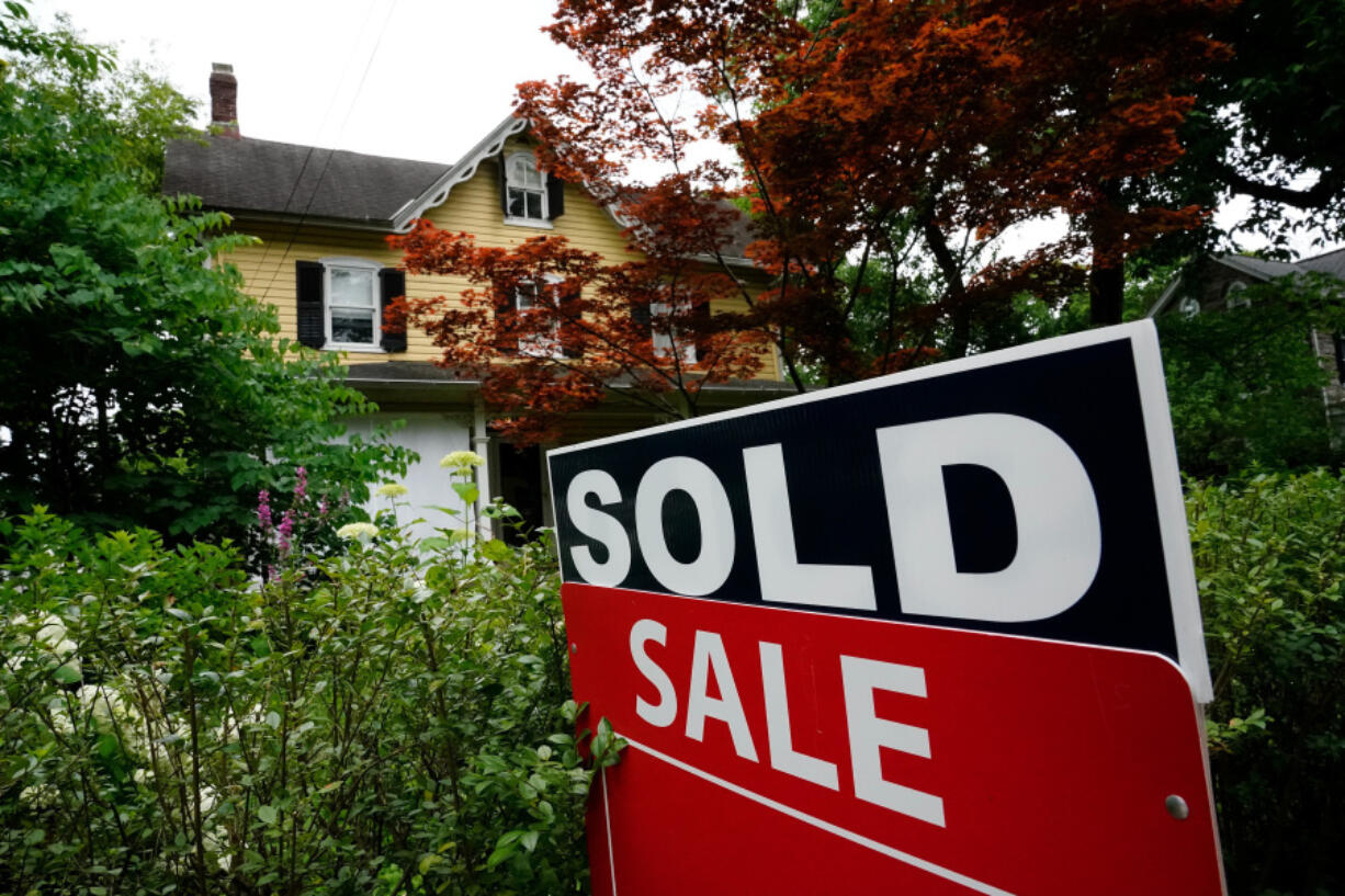 A sale sign stands outside a home in Wyndmoor, Pa., in 2022. The National Association of Realtors agreed  Friday to pay $418 million and change its rules to settle lawsuits claiming homeowners have been unfairly forced to pay artificially inflated agent commissions.