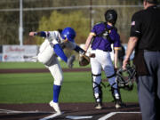 Ridgefield's Deven Savella, left, celebrates a run scored by stomping his foot at home plate during the Spudders' 2A Greater St. Helens League baseball game against Columbia River on Friday, March 29, 2024, at Ridgefield Outdoor Recreation Complex.